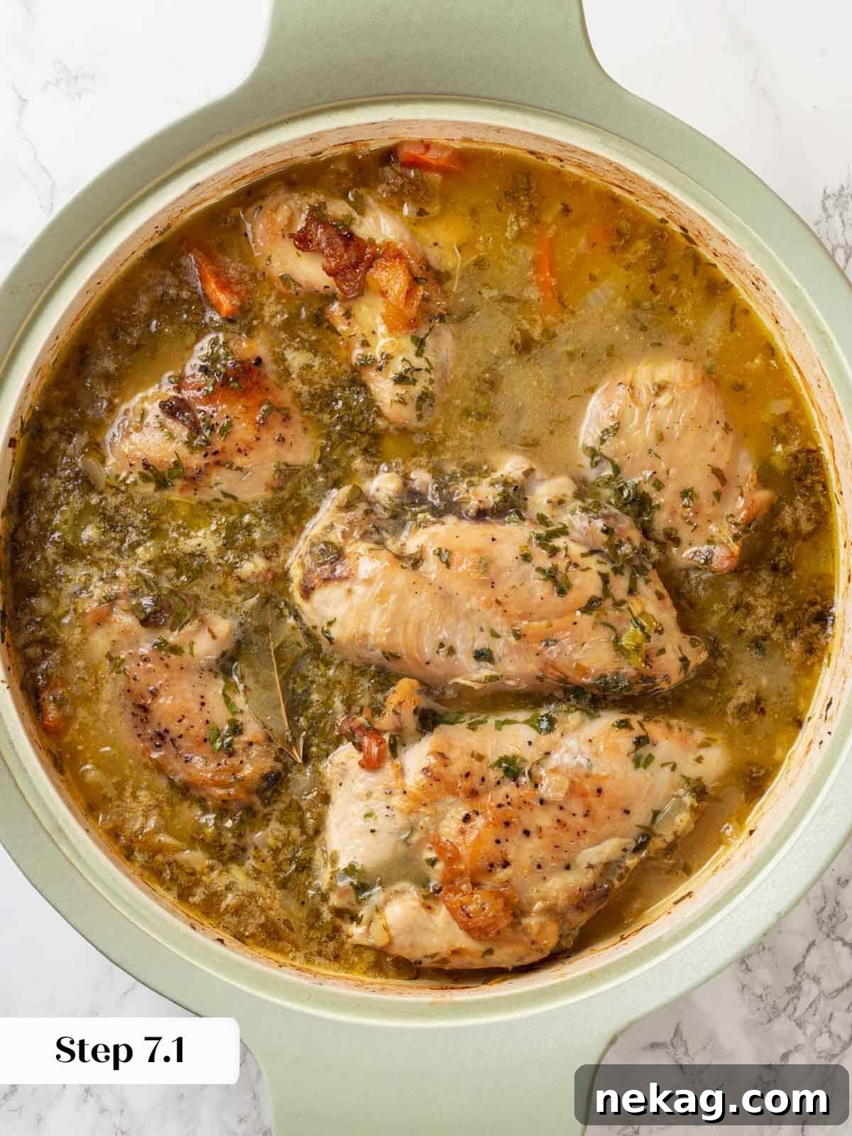 Chicken in wine sauce baked in skillet.