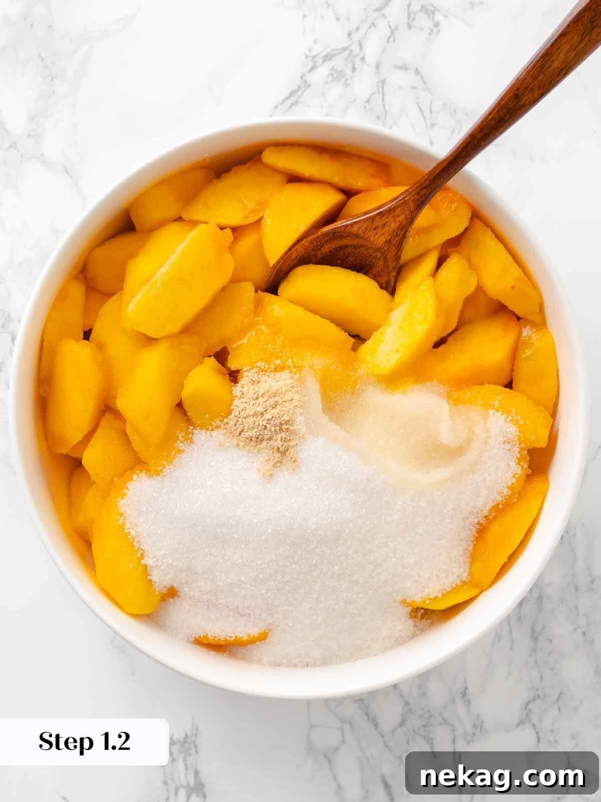 Warm Buttery Peach Crisp 6 Sliced peaches mixed with sugar and lemon, beginning the preparation for the peach crisp filling.