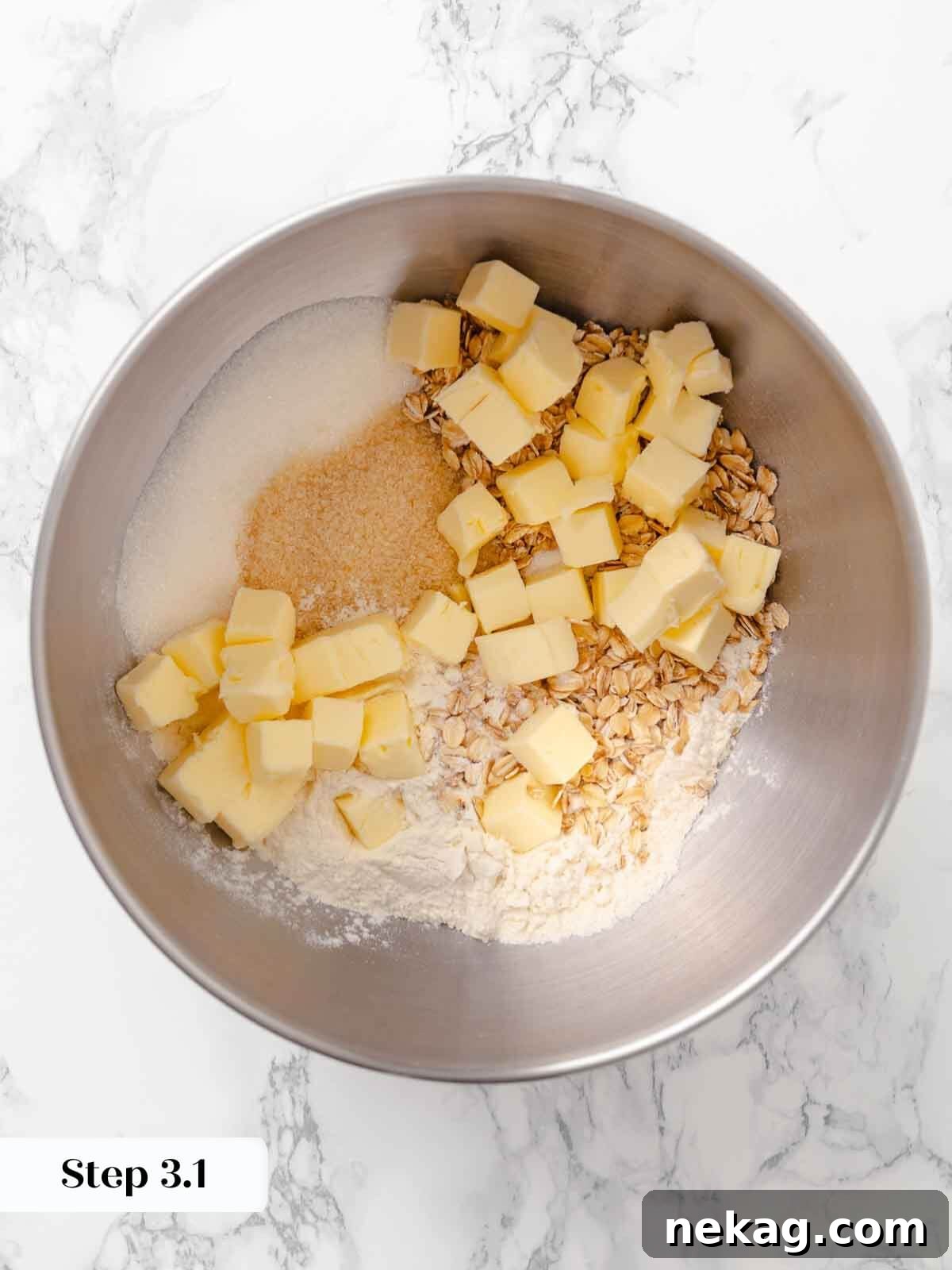 Warm Buttery Peach Crisp 7 Cubed cold butter being mixed into the dry ingredients for the peach crisp topping.
