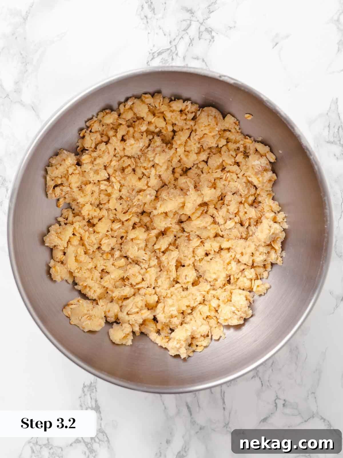 Warm Buttery Peach Crisp 8 Crumbly streusel topping for peach crisp in a silver bowl, showing the perfect texture before assembly.