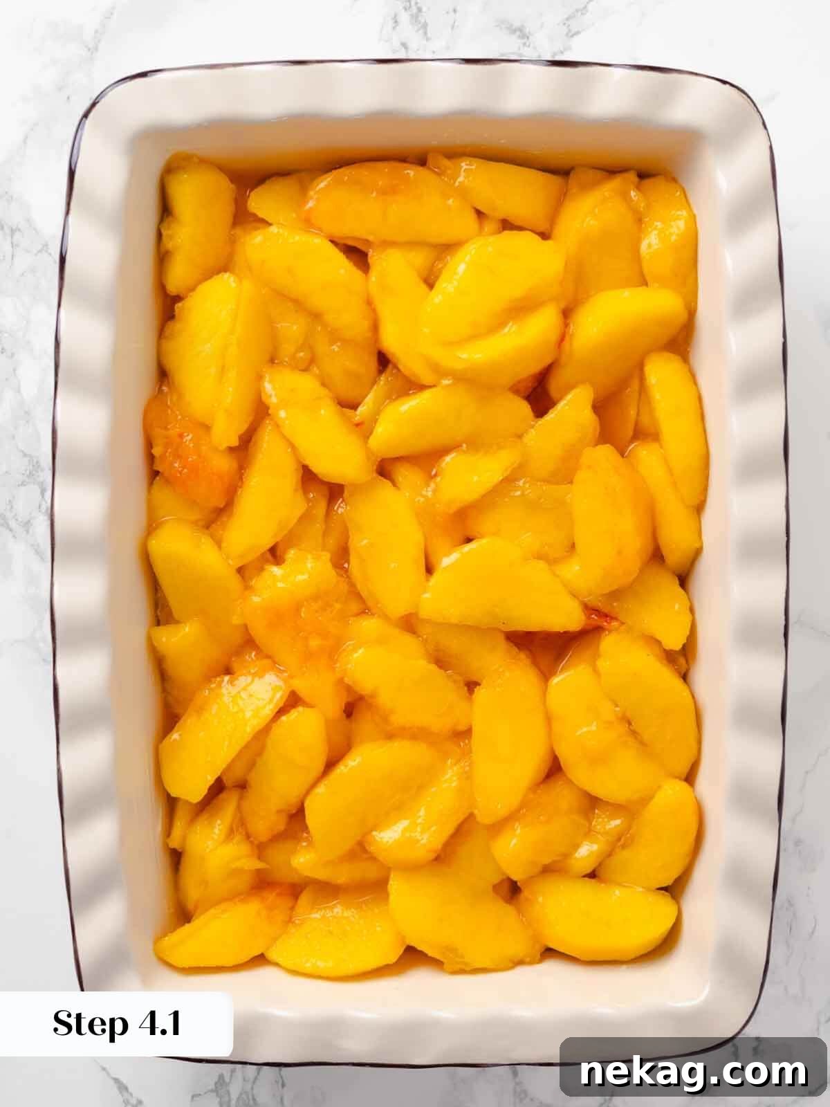Warm Buttery Peach Crisp 9 Peach mixture spread in a baking dish, perfectly prepared to be topped with streusel.