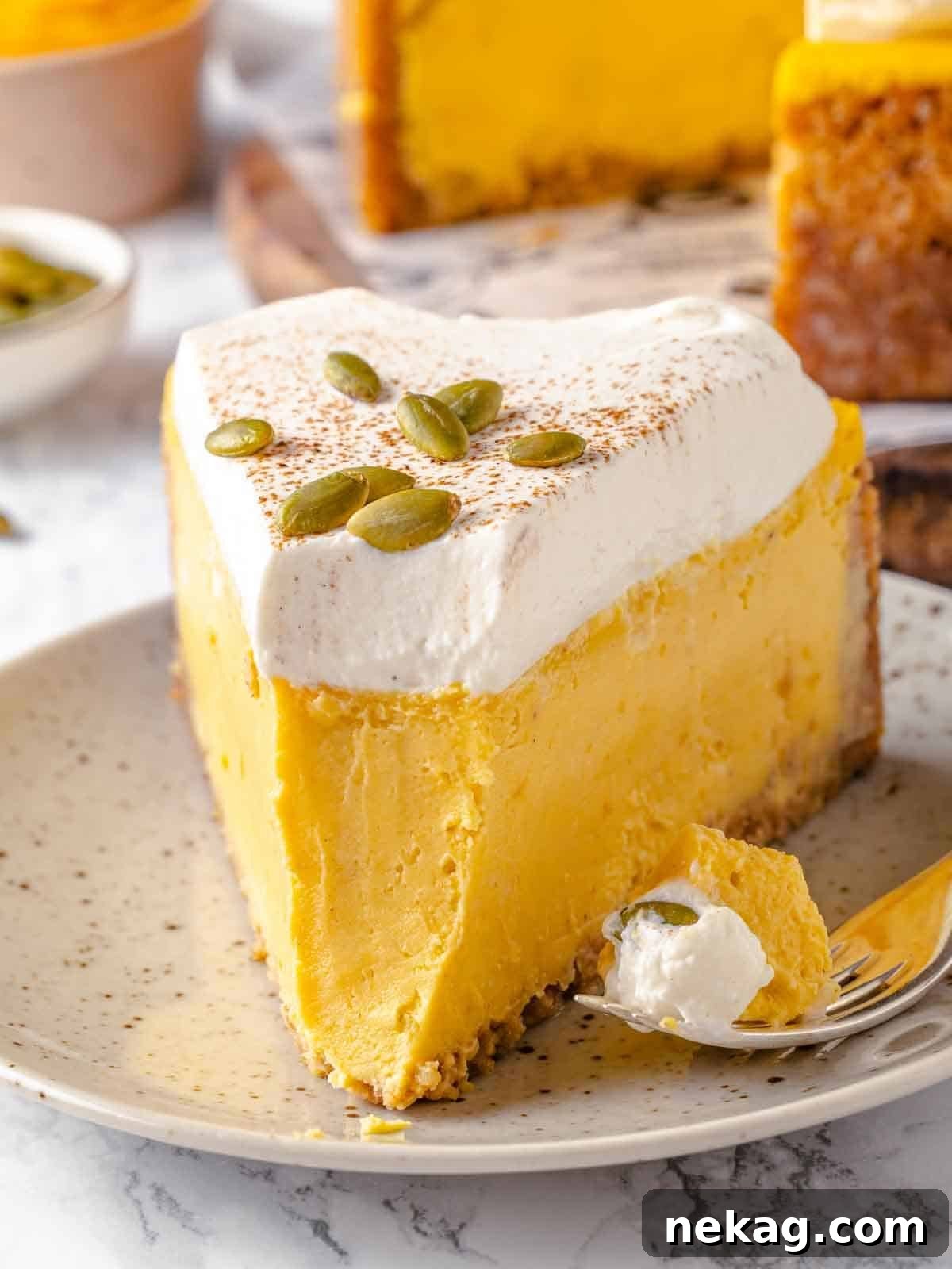 Velvet Pumpkin Bliss 2 A forkful of pumpkin cheesecake showing its creamy texture and gingersnap crust.