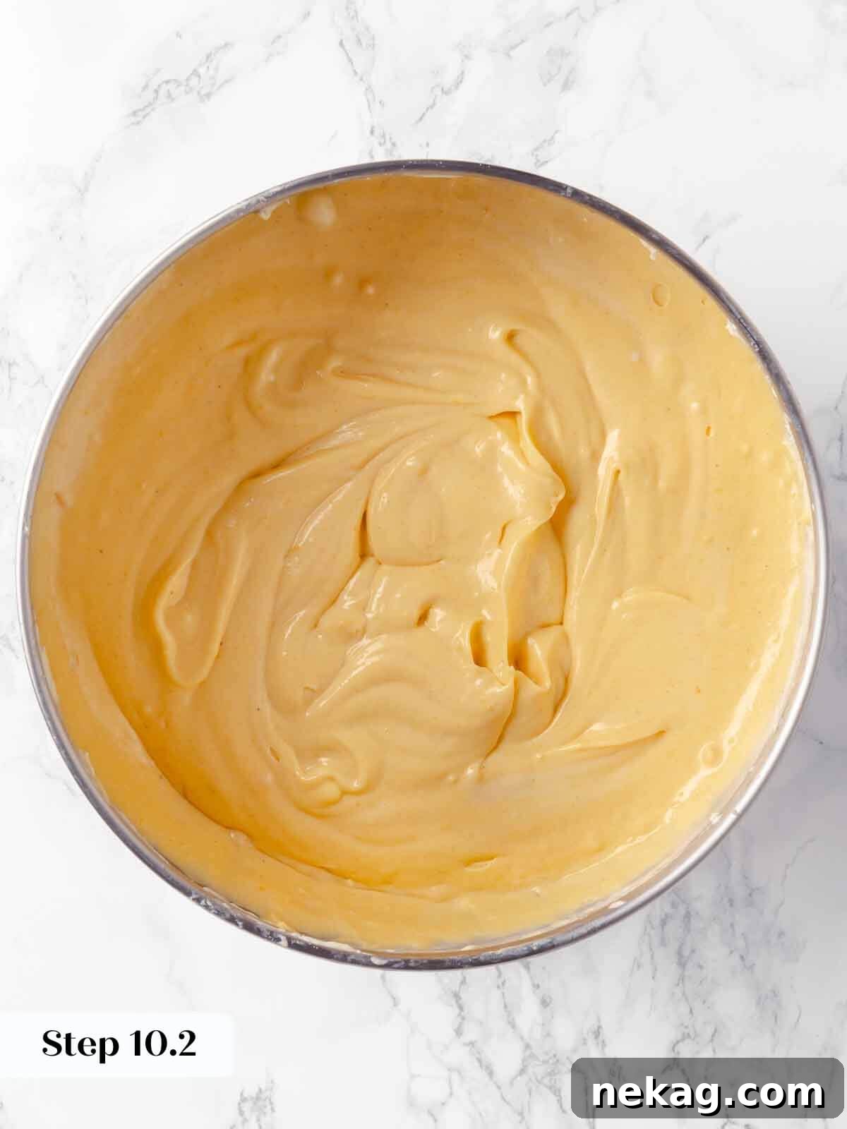 Velvet Pumpkin Bliss 15 Pumpkin puree blended into the cheesecake batter, resulting in a smooth orange mixture.