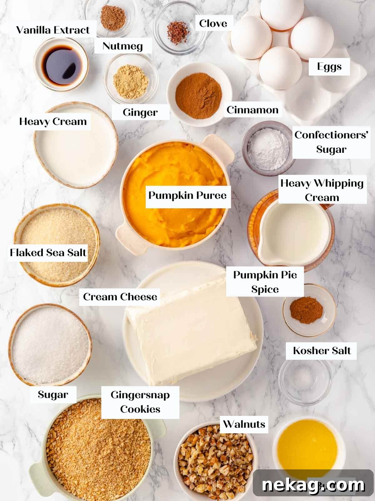 Velvet Pumpkin Bliss 4 All the necessary pumpkin cheesecake ingredients laid out on a white marble countertop, ready for baking.
