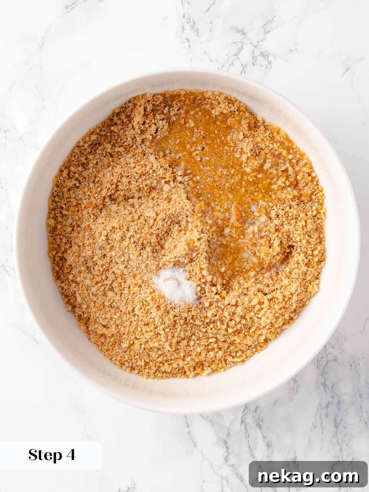 Velvet Pumpkin Bliss 7 Mixing the gingersnap crumb, butter, and salt for the pumpkin cheesecake crust.