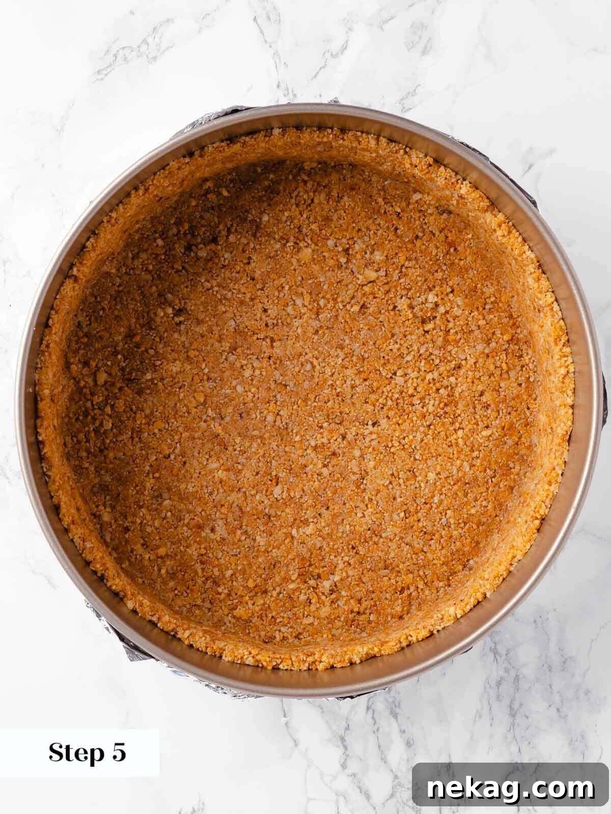 Velvet Pumpkin Bliss 8 The pumpkin cheesecake cookie crust pressed firmly into the springform pan, ready for baking.