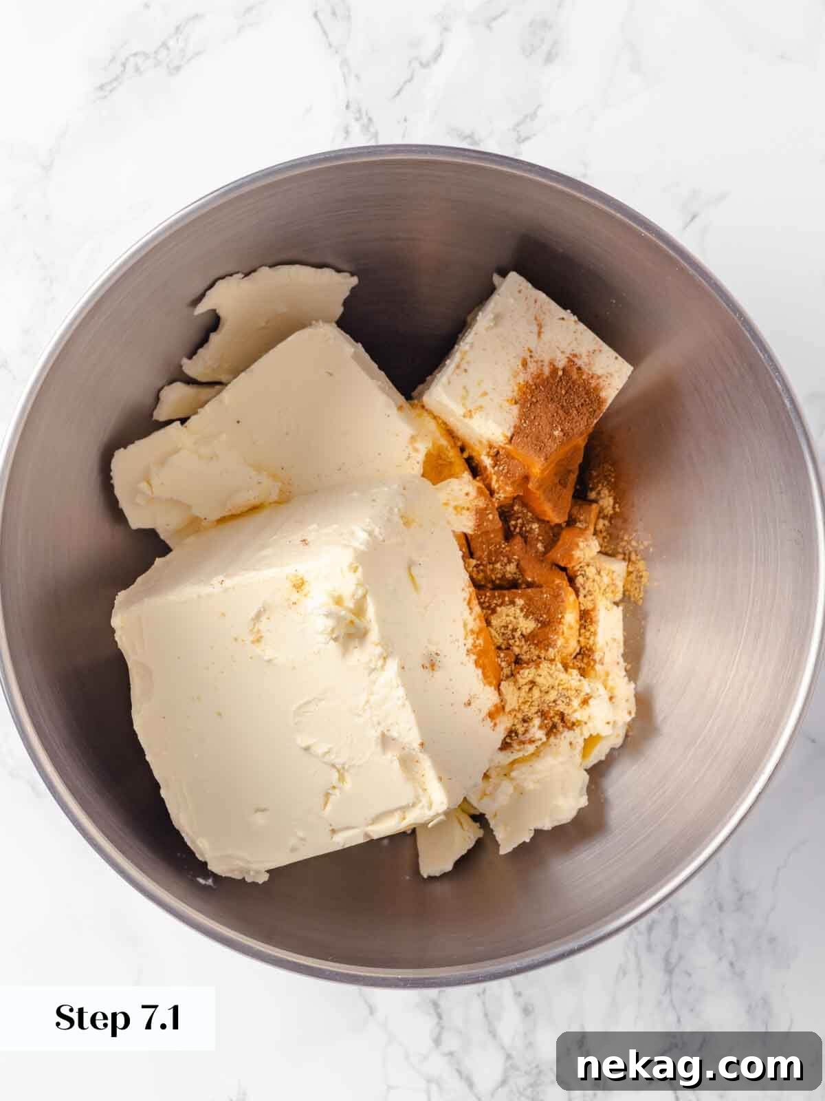 Velvet Pumpkin Bliss 9 Unbeaten cream cheese in a mixing bowl, ready for the pumpkin cheesecake preparation.