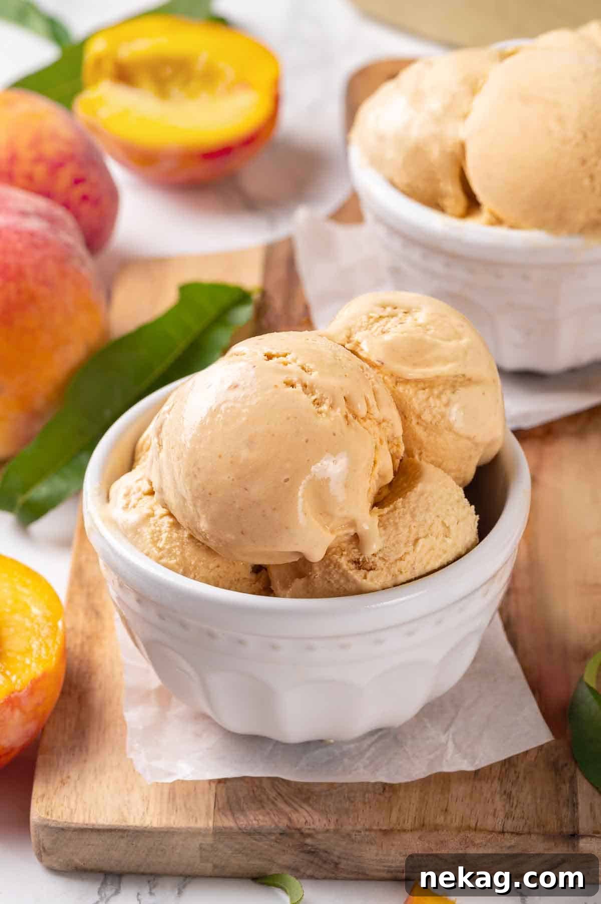 Fresh Peach Bliss 3 Close-up of creamy scoops of homemade peach ice cream in a white bowl, highlighting its smooth texture and rich color.