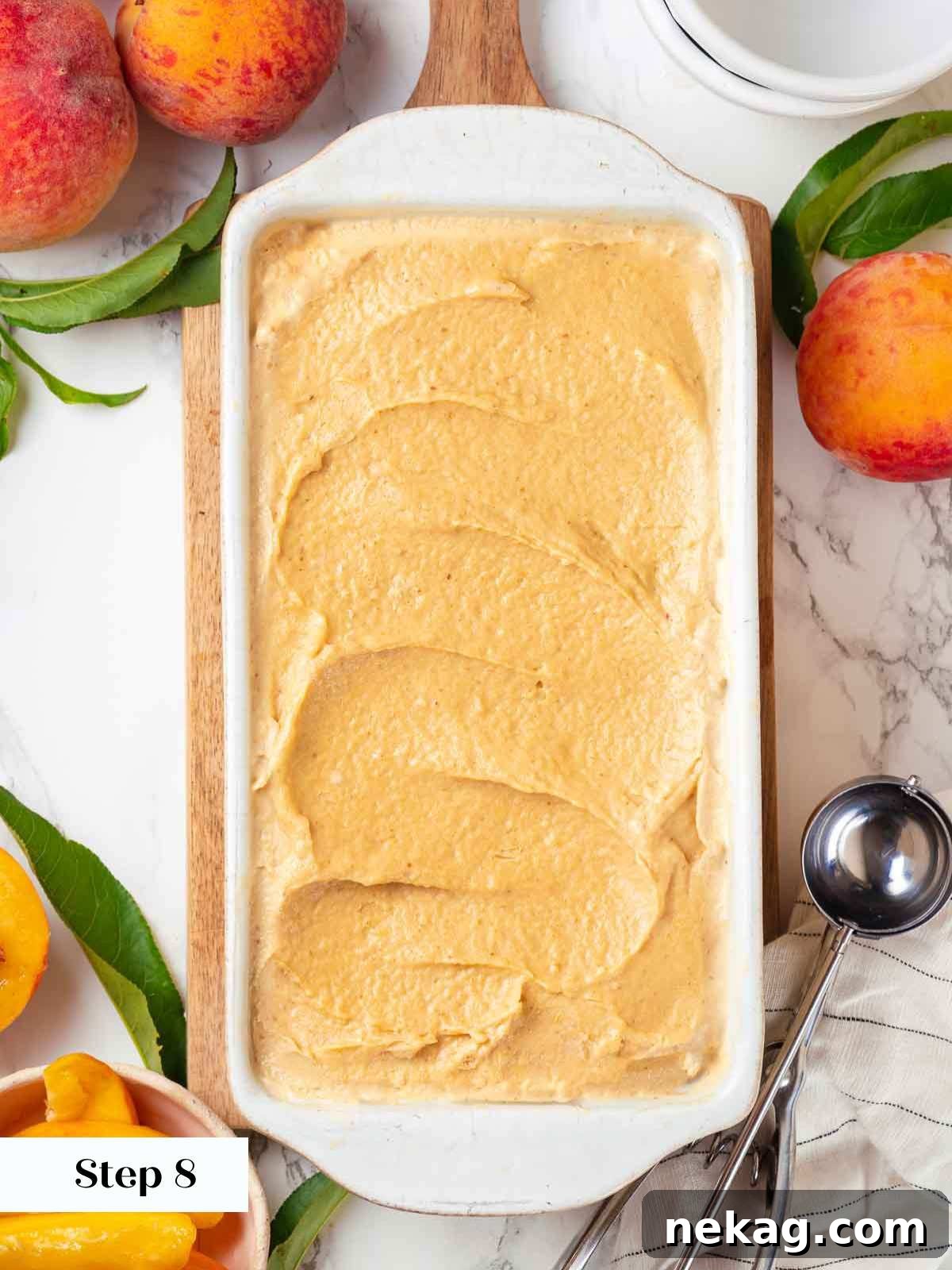 Fresh Peach Bliss 10 Freshly churned peach ice cream smoothed into a freezer-safe container, ready for its final hardening in the freezer.