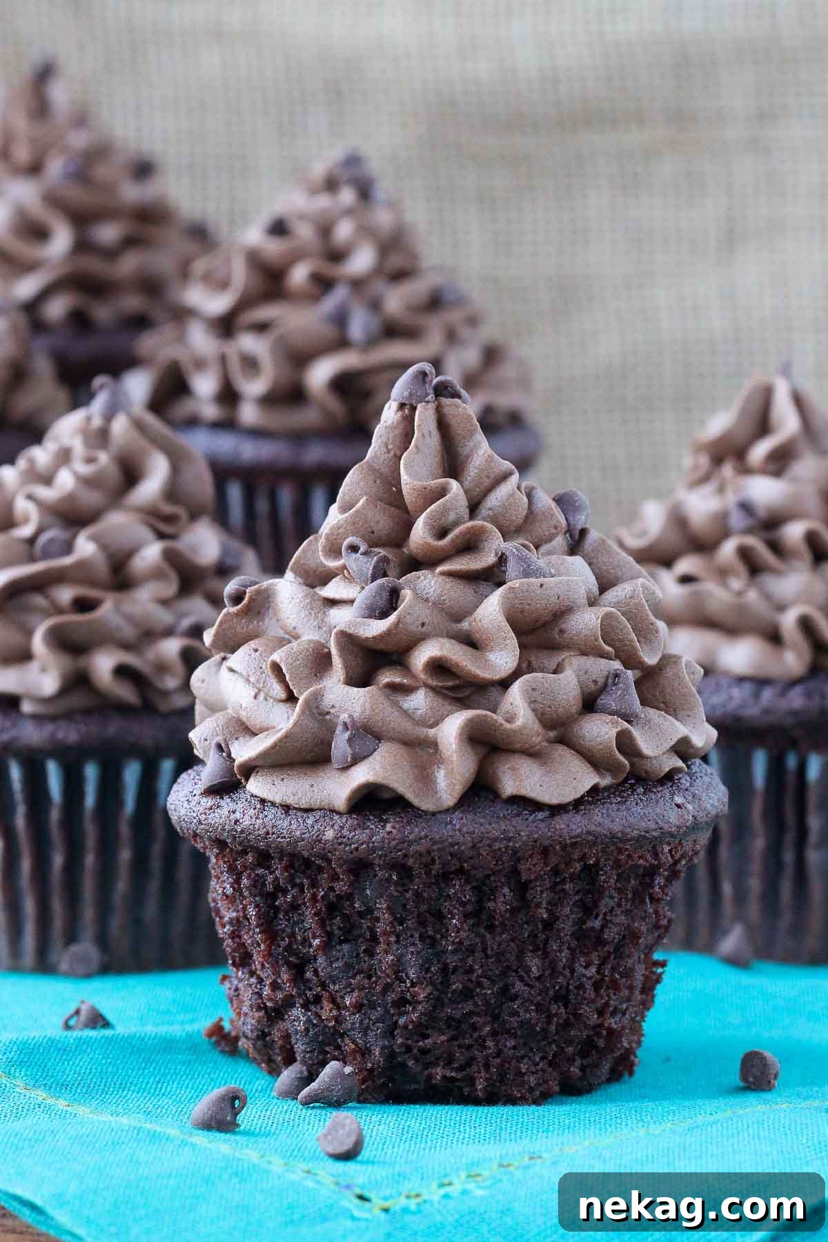 chocolate cupcake with chocolate frosting teal napkin.