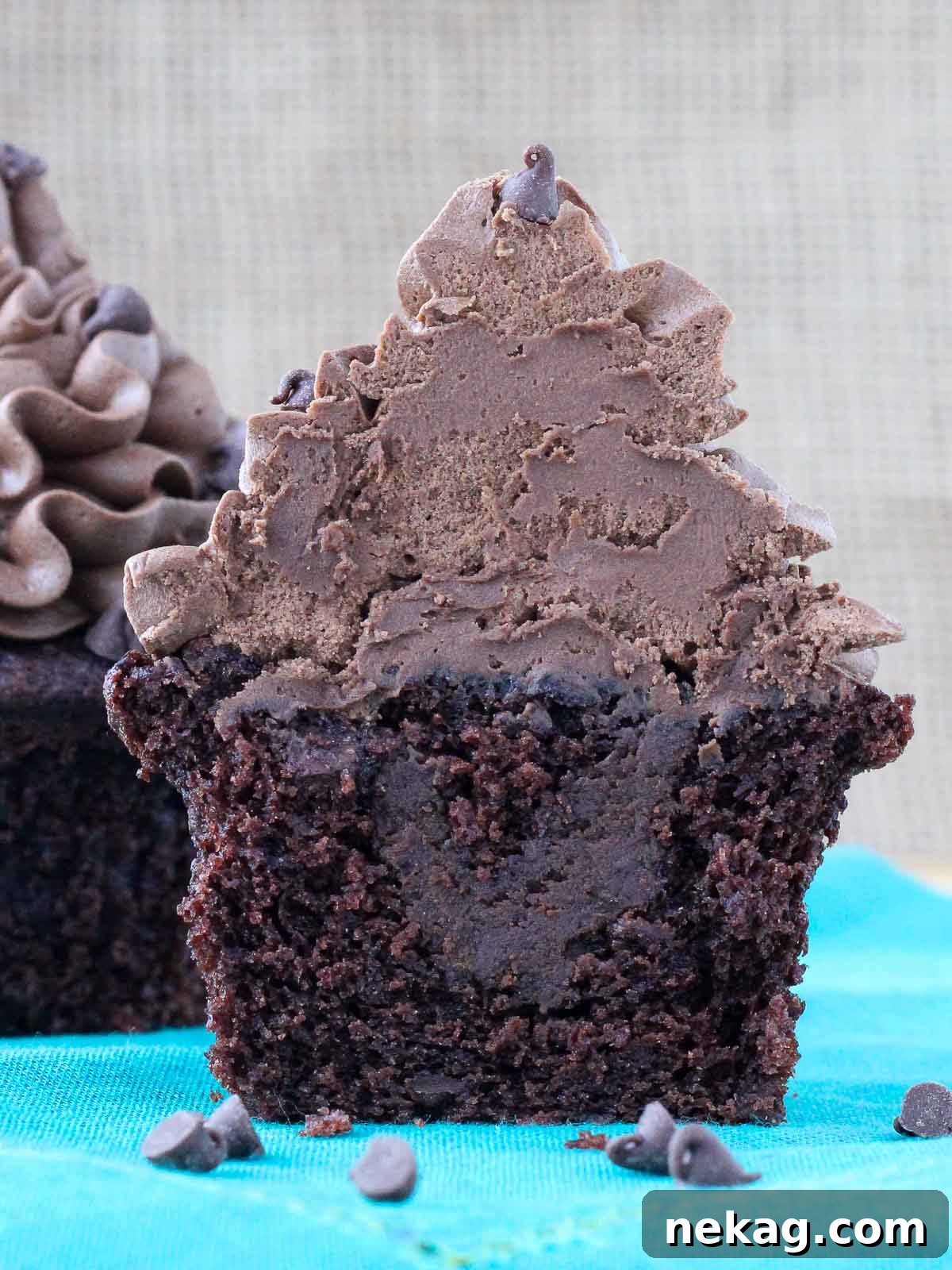chocolate cupcake with chocolate ganache filling cut in half.
