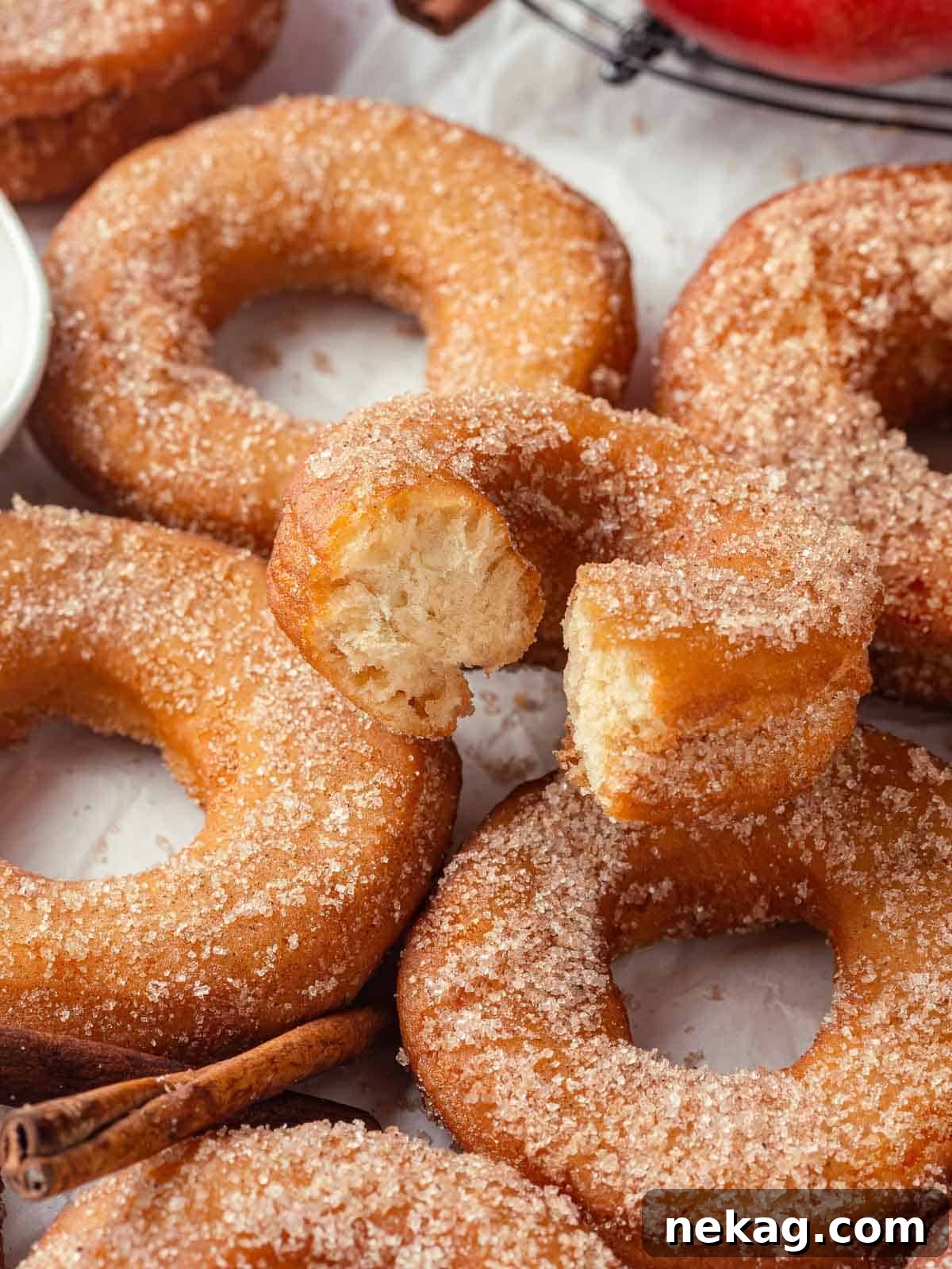 Harvest Apple Cider Donuts 20 A group of apple cider donuts resting on a countertop, highlighting their warm, sugared coating.