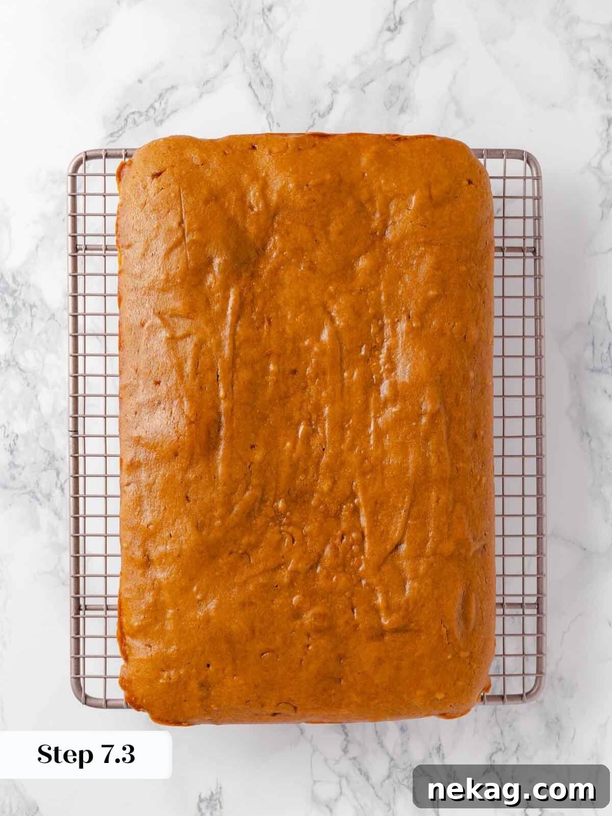 Autumn Spice Squares 12 Baked pumpkin bars cooling completely on a metal wire rack after being removed from the oven.