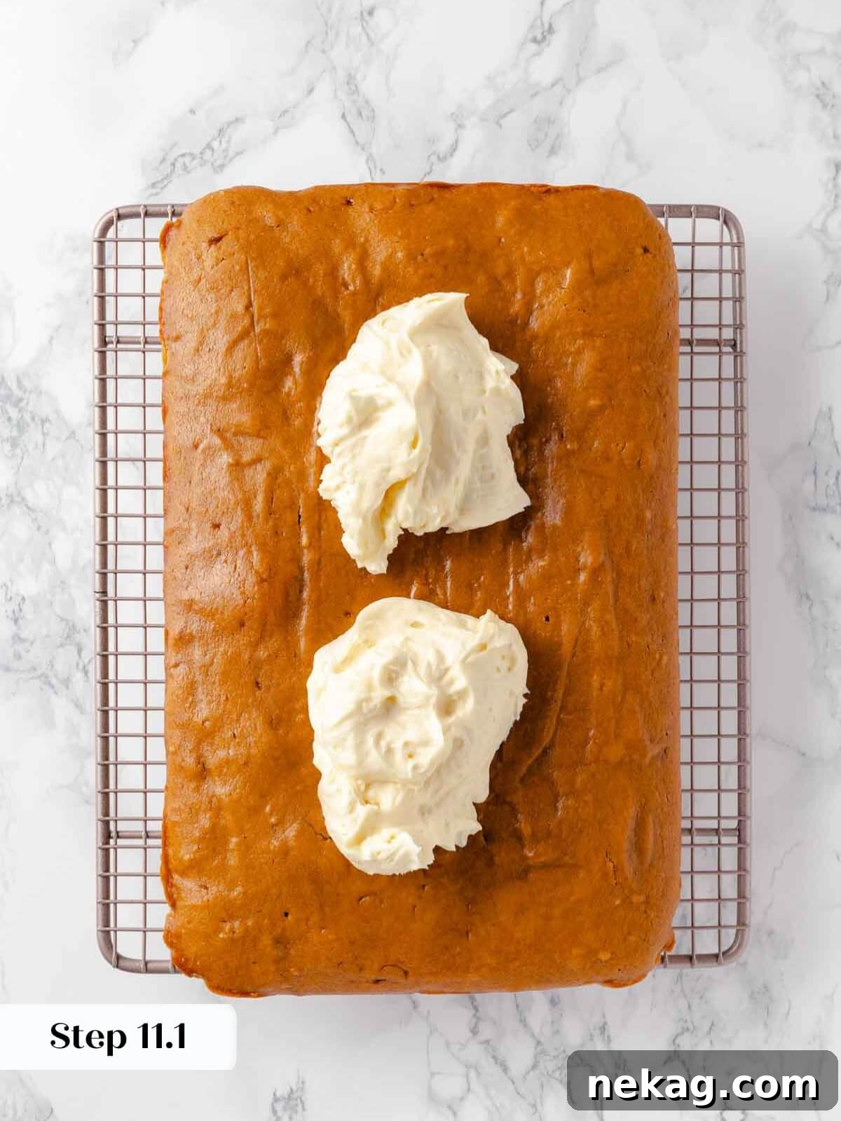 Autumn Spice Squares 15 Generous dollops of creamy frosting spread on top of cooled pumpkin bars, ready to be smoothed.