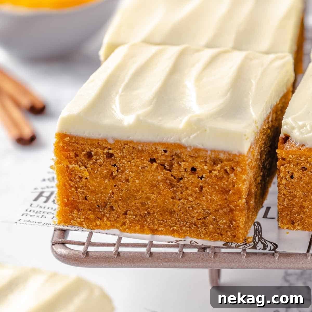 Autumn Spice Squares 3 The tender, moist inside of a pumpkin bar, highlighting its soft and inviting texture.