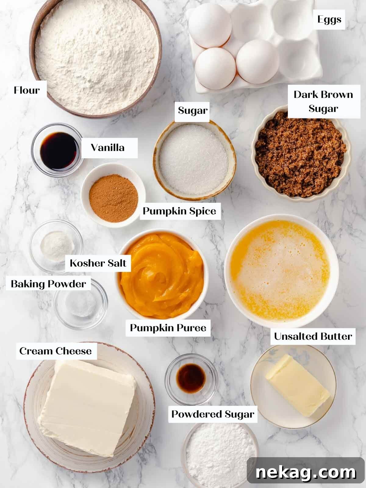 Autumn Spice Squares 4 All the necessary ingredients for pumpkin bars neatly arranged on a white marble surface.
