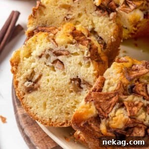A close-up view of the interior of a Jewish apple cake, showing the intricate layers of cake and softened apple slices.