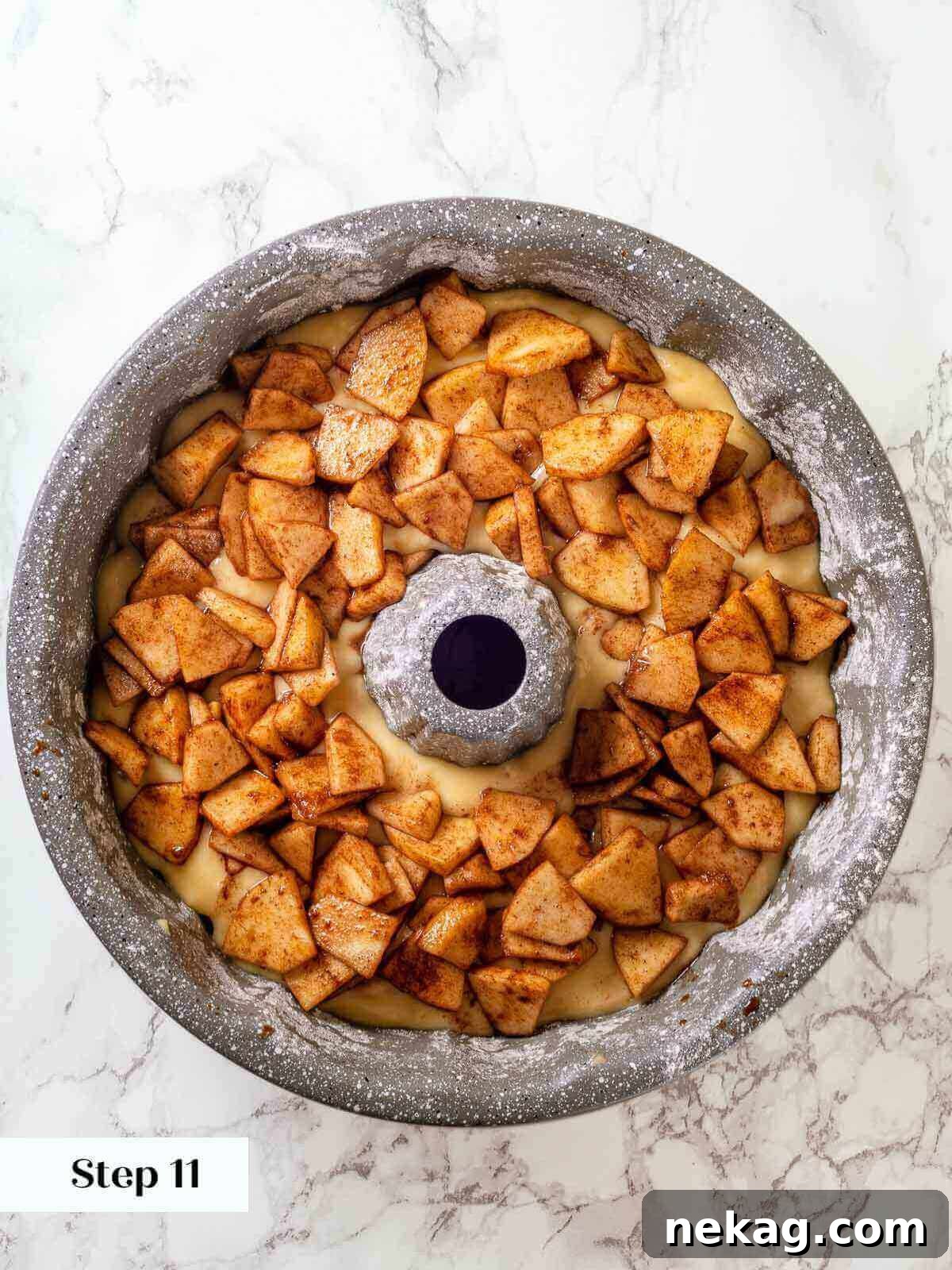 Spiced Apple Harvest Cake 10 The final layer of seasoned apples meticulously arranged on top of the unbaked Jewish apple cake, ready for the oven.