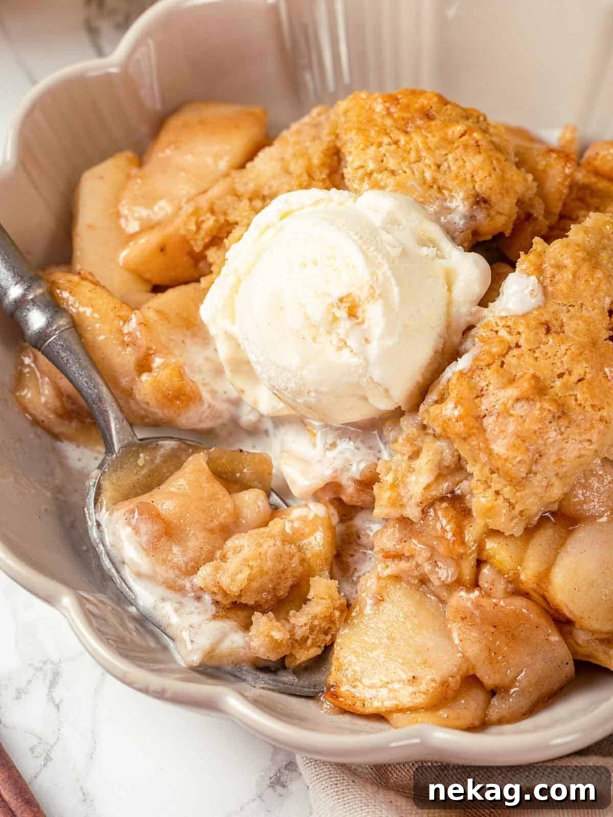 Apple cobbler in a white bowl, ready to enjoy.