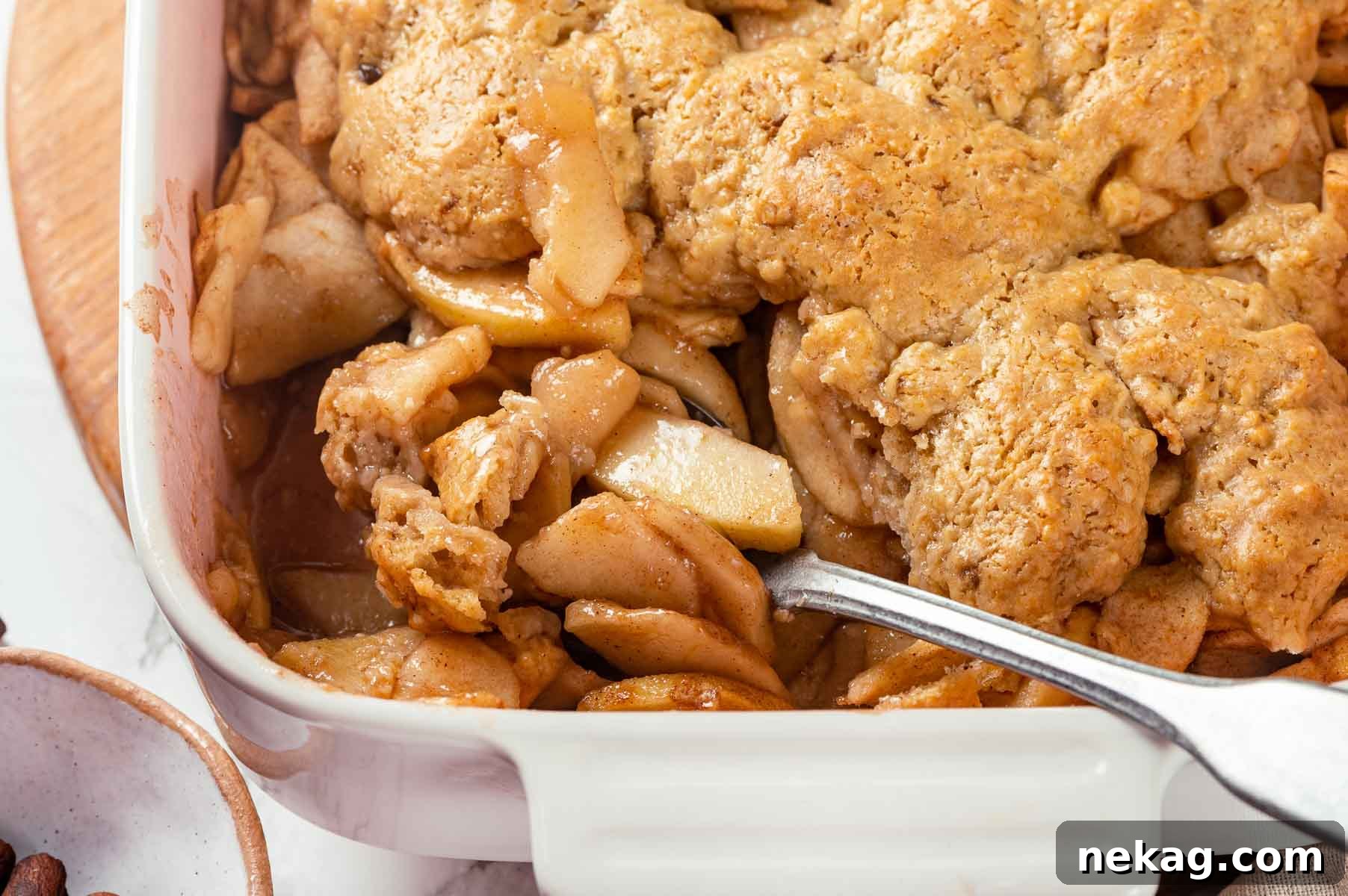 Inside view of apple cobbler showing spiced apple filling.