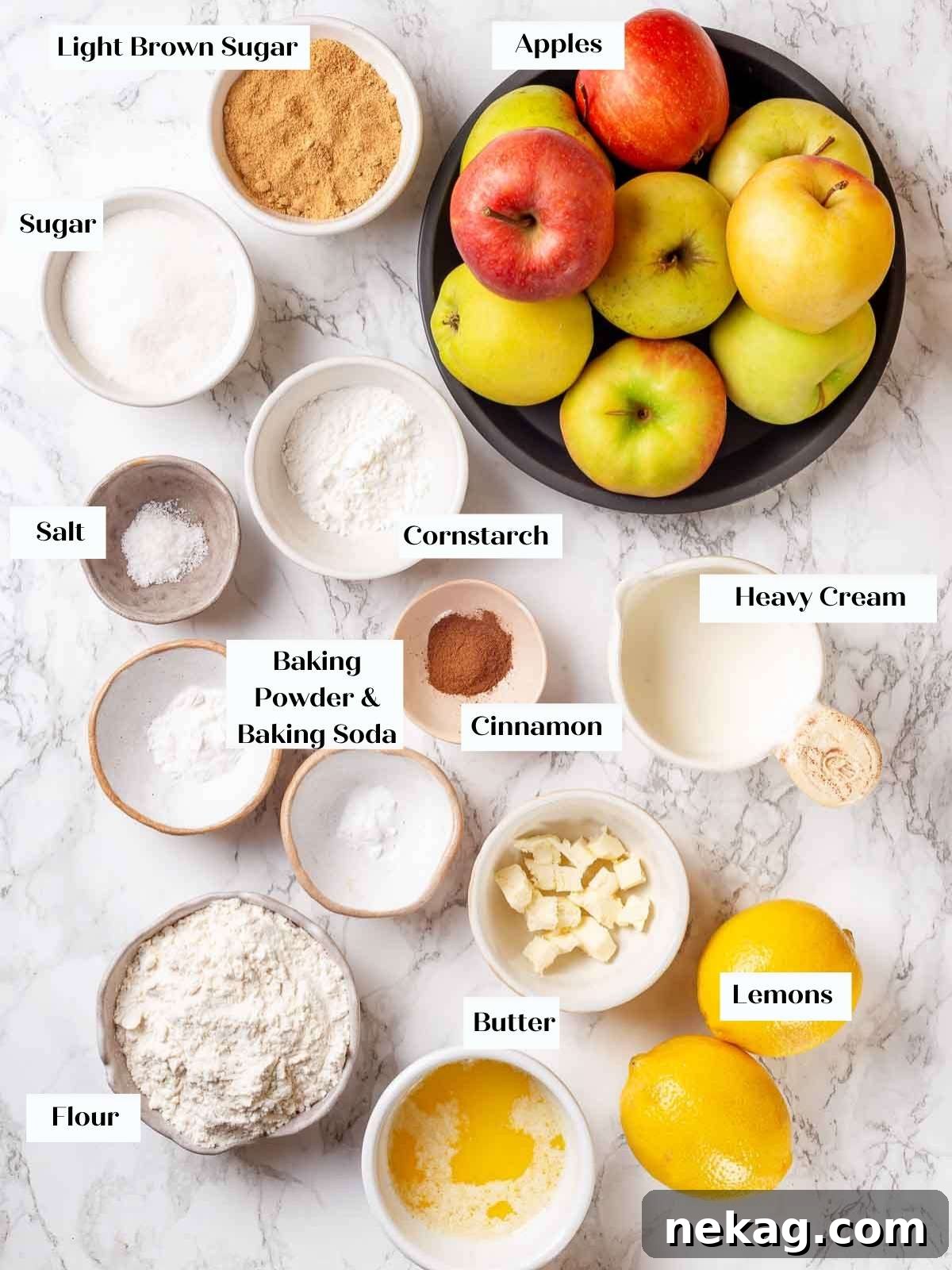 Ingredients for apple cobbler arranged on a marble surface.