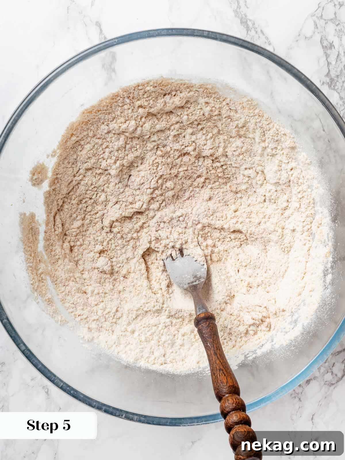 Dry ingredients for apple cobbler biscuit topping in a mixing bowl.