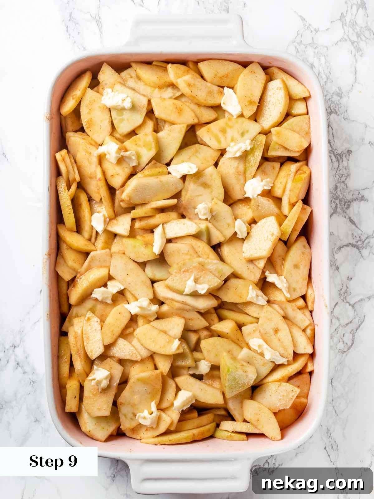 Apple cobbler topped with small dots of butter before baking.
