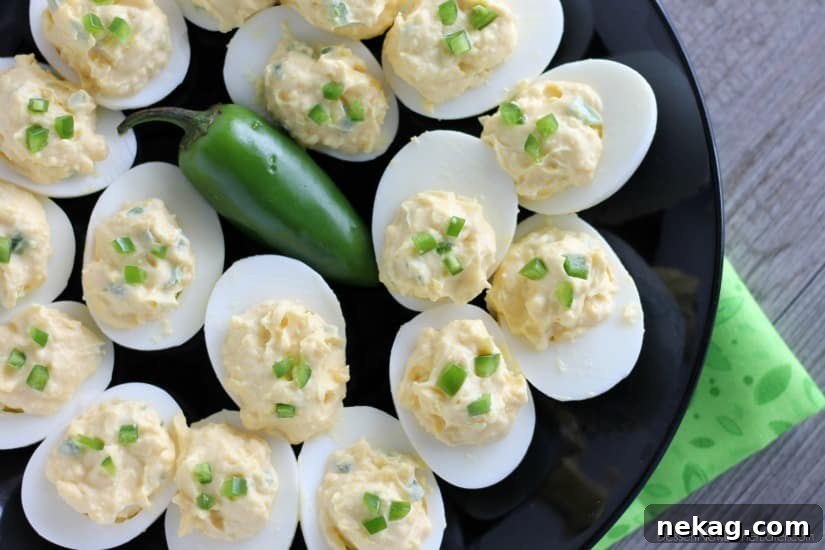 Close-up of freshly prepared MIRACLE WHIP Spicy Deviled Eggs, garnished with jalapeño slices.