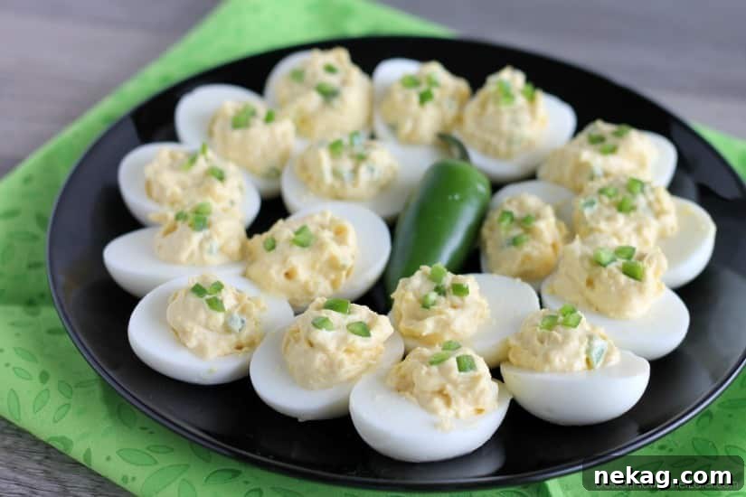 A close-up of the creamy filling being piped into egg white halves for Spicy Deviled Eggs.