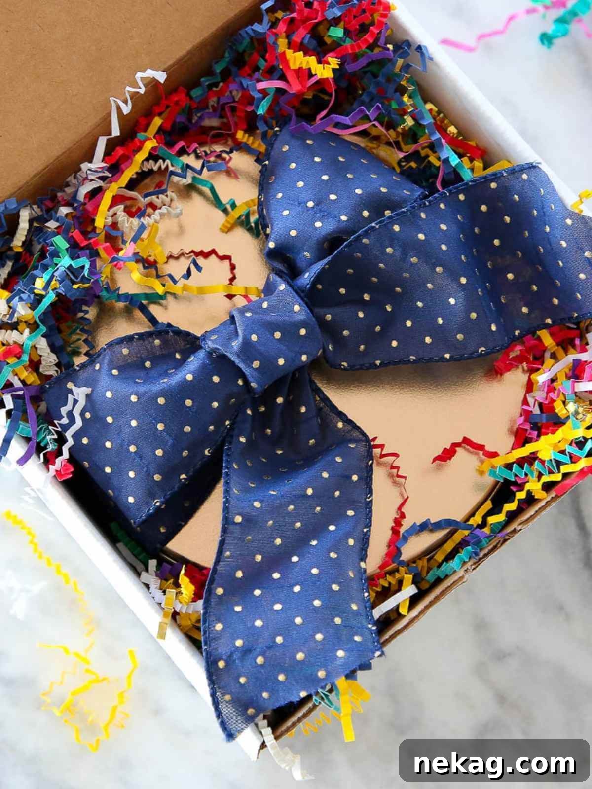 A beautifully decorated cookie tin tied with a festive ribbon, perfect for holiday gifting to a home cook.