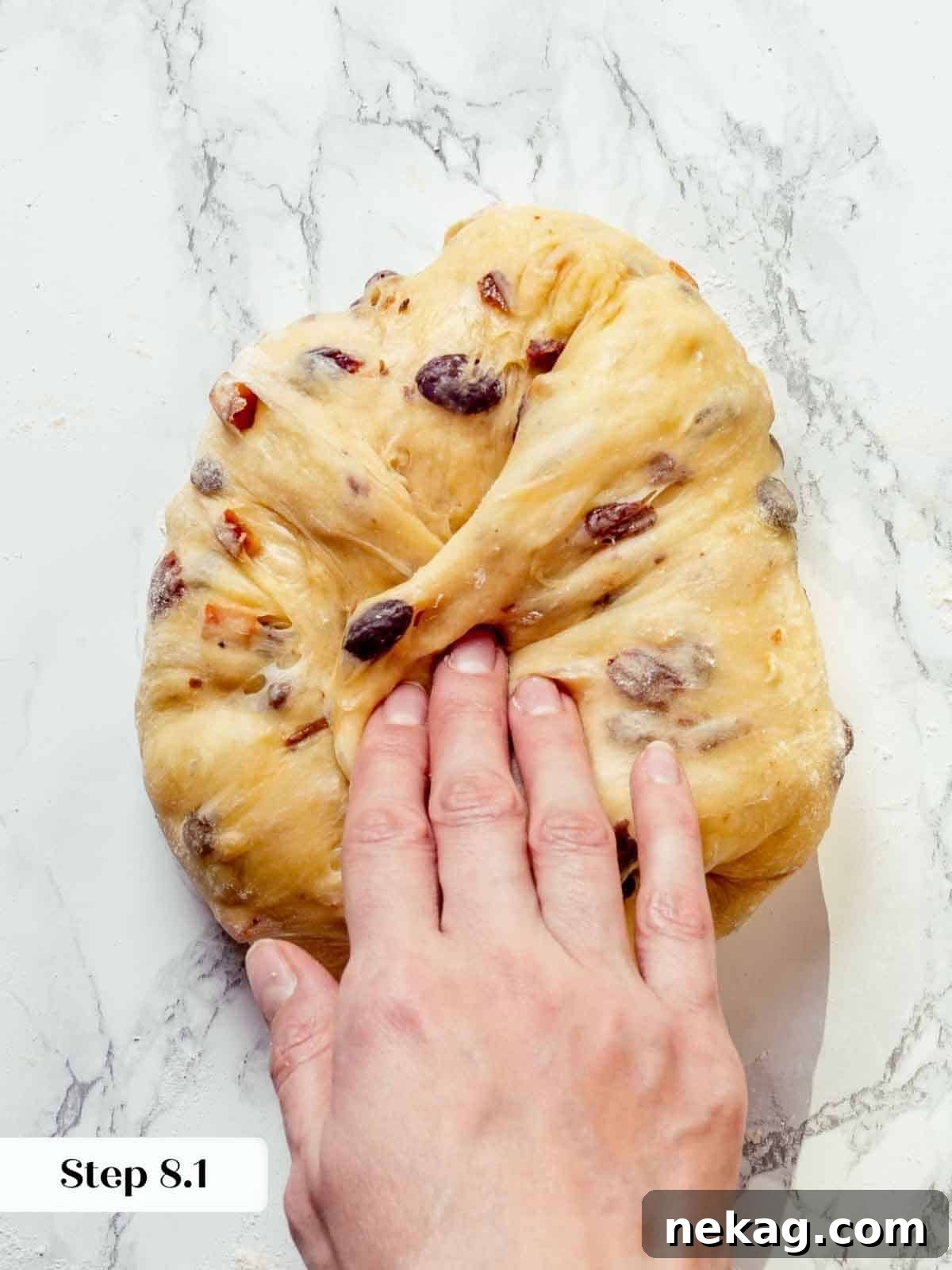 Panettone dough undergoing final shaping with folds to create a strong structure.