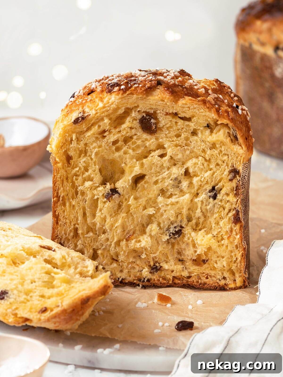 A beautifully baked loaf of panettone, sliced to reveal its incredibly fluffy and airy interior.
