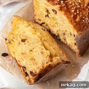 A slice of panettone bread, showing its fluffy texture and golden crust.