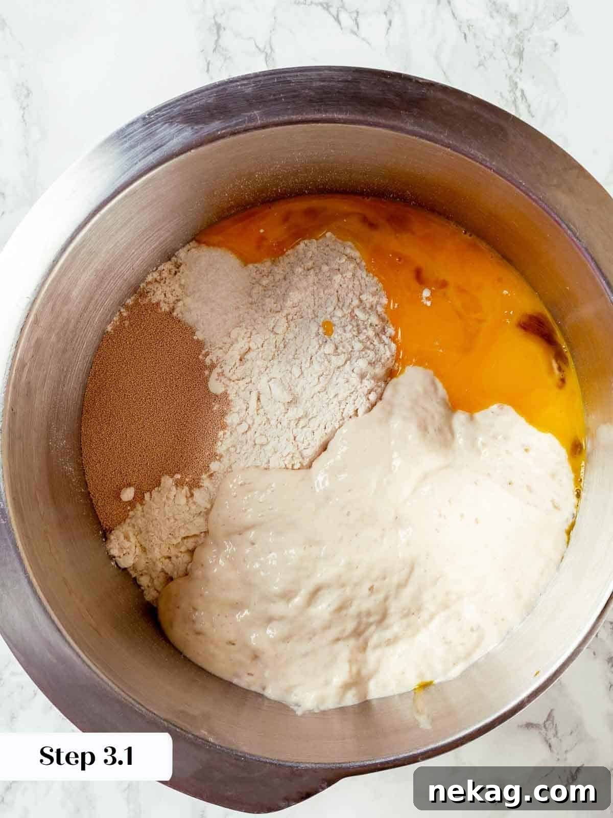 Egg yolks and dry ingredients being mixed in a stand mixer to start the panettone dough.