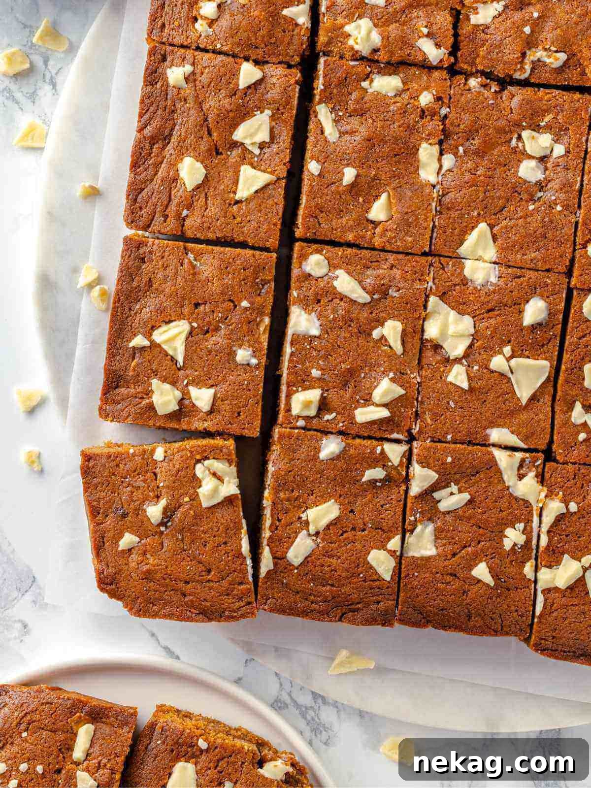 Festive Gingerbread Blondies 12 A glorious pan of freshly baked gingerbread blondies, their golden-brown edges and soft, spiced interiors promising a delightful treat.