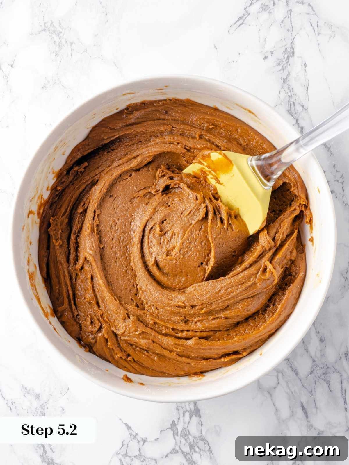 Festive Gingerbread Blondies 9 A beautifully textured gingerbread blondie batter, rich and uniform, sits in a mixing bowl, perfectly prepared to be poured into the baking pan.