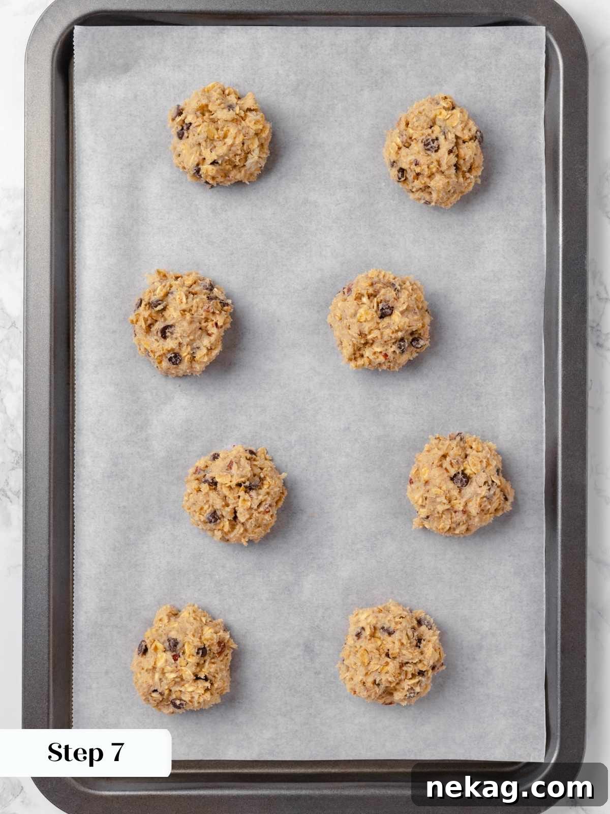 Hearty Cowboy Cookie Bake 15 Perfectly portioned cookie dough balls, generously spaced on a lined baking tray, gleaming and ready for the oven to transform them into delicious cowboy cookies.