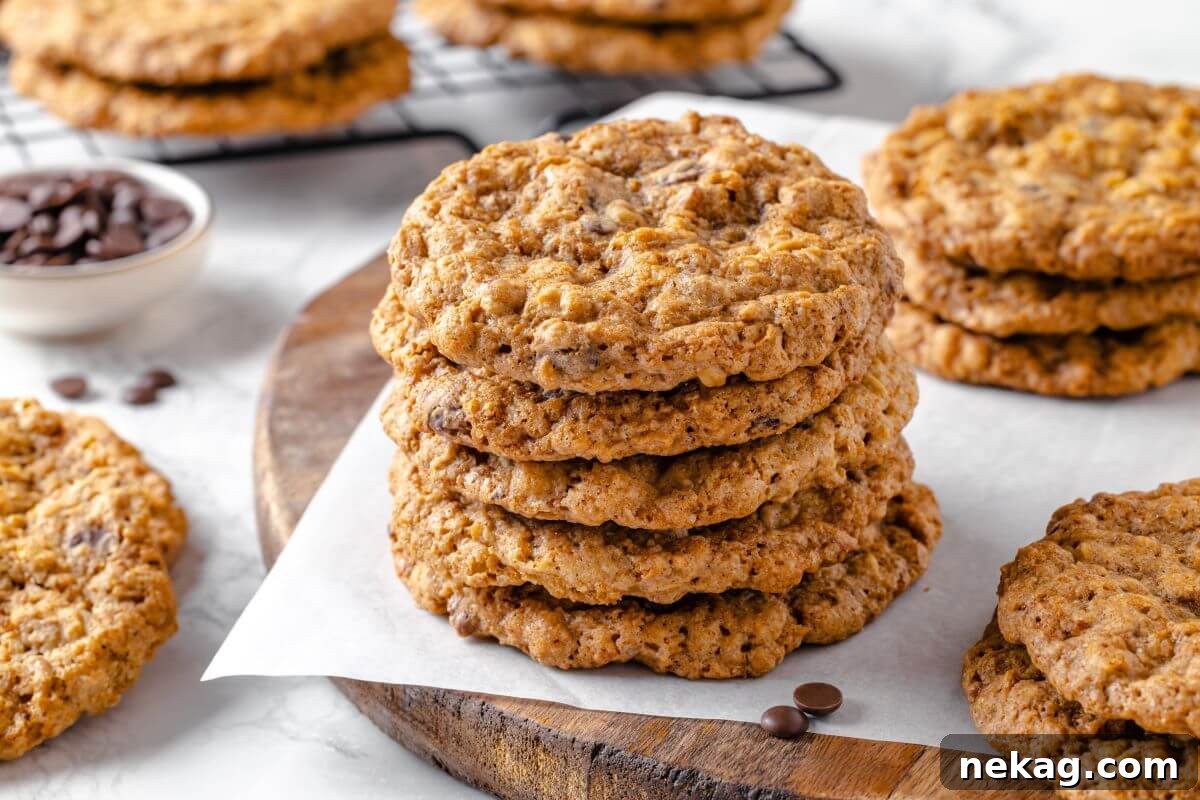 Hearty Cowboy Cookie Bake 17 A high-angle shot of a beautiful stack of perfectly baked cowboy cookies, clearly displaying the rich medley of chocolate chips, oats, and pecans, invitingly ready for enjoyment.