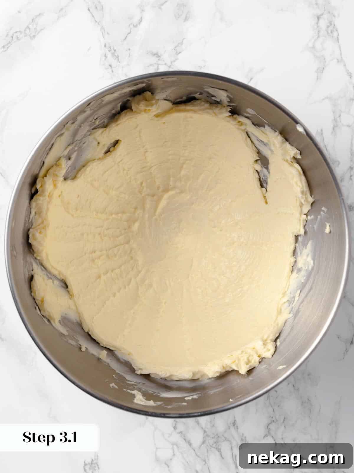 Hearty Cowboy Cookie Bake 6 Softened unsalted butter being beaten in a stand mixer until light and creamy, forming the essential base of the cowboy cookie dough, indicating perfect aeration.