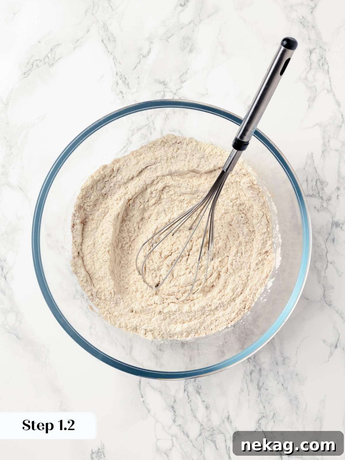 Butter and sugar being creamed in a stand mixer.