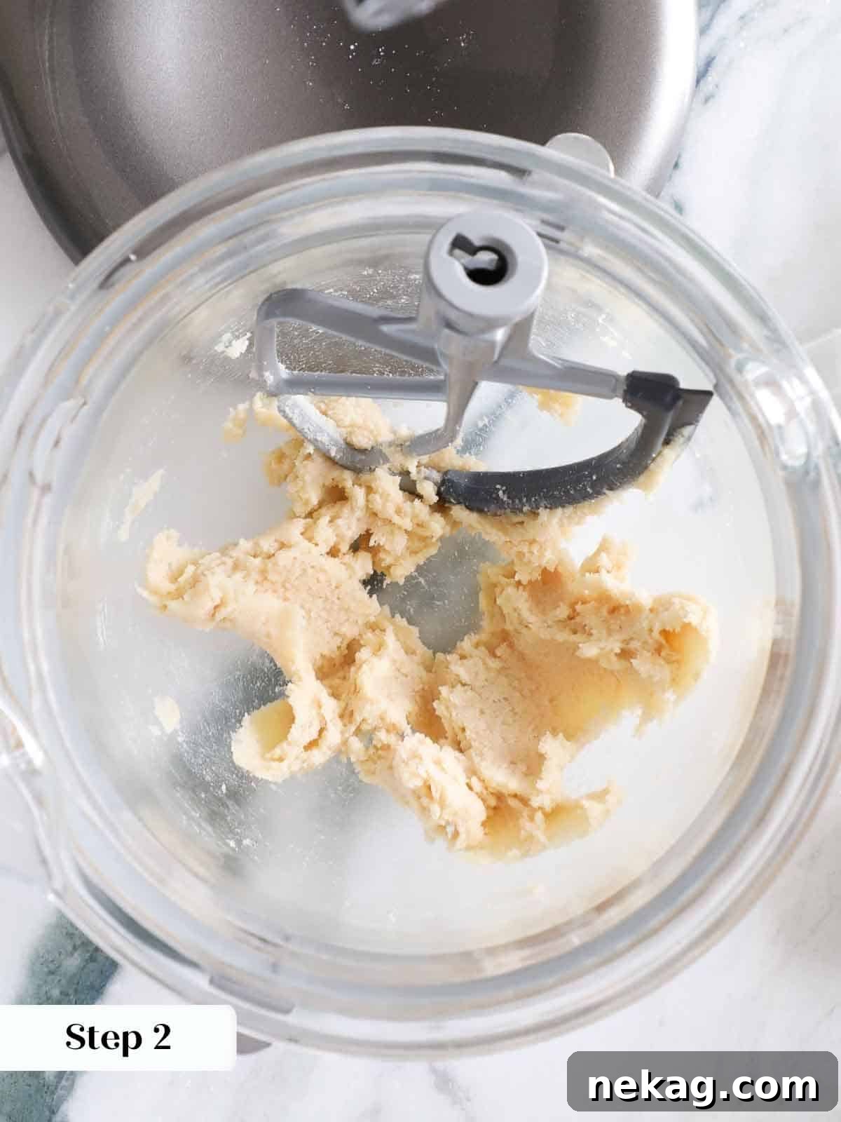 Creamy butter and sugars perfectly blended in a mixing bowl, creating a smooth, light base for the monster cookie dough.