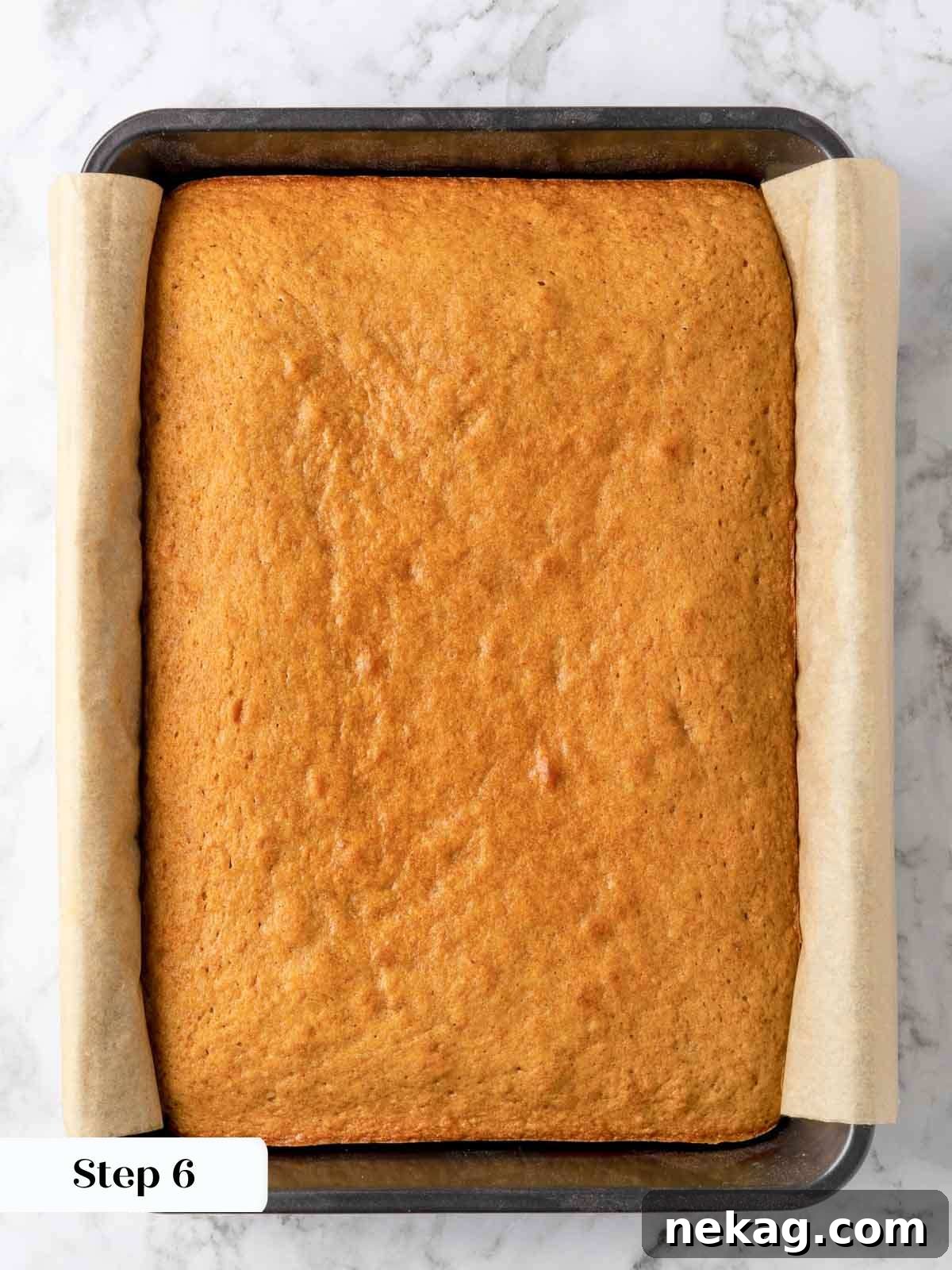 A freshly baked, golden-brown banana cake cooling gently in its baking pan after being removed from the oven, emitting a delicious aroma.