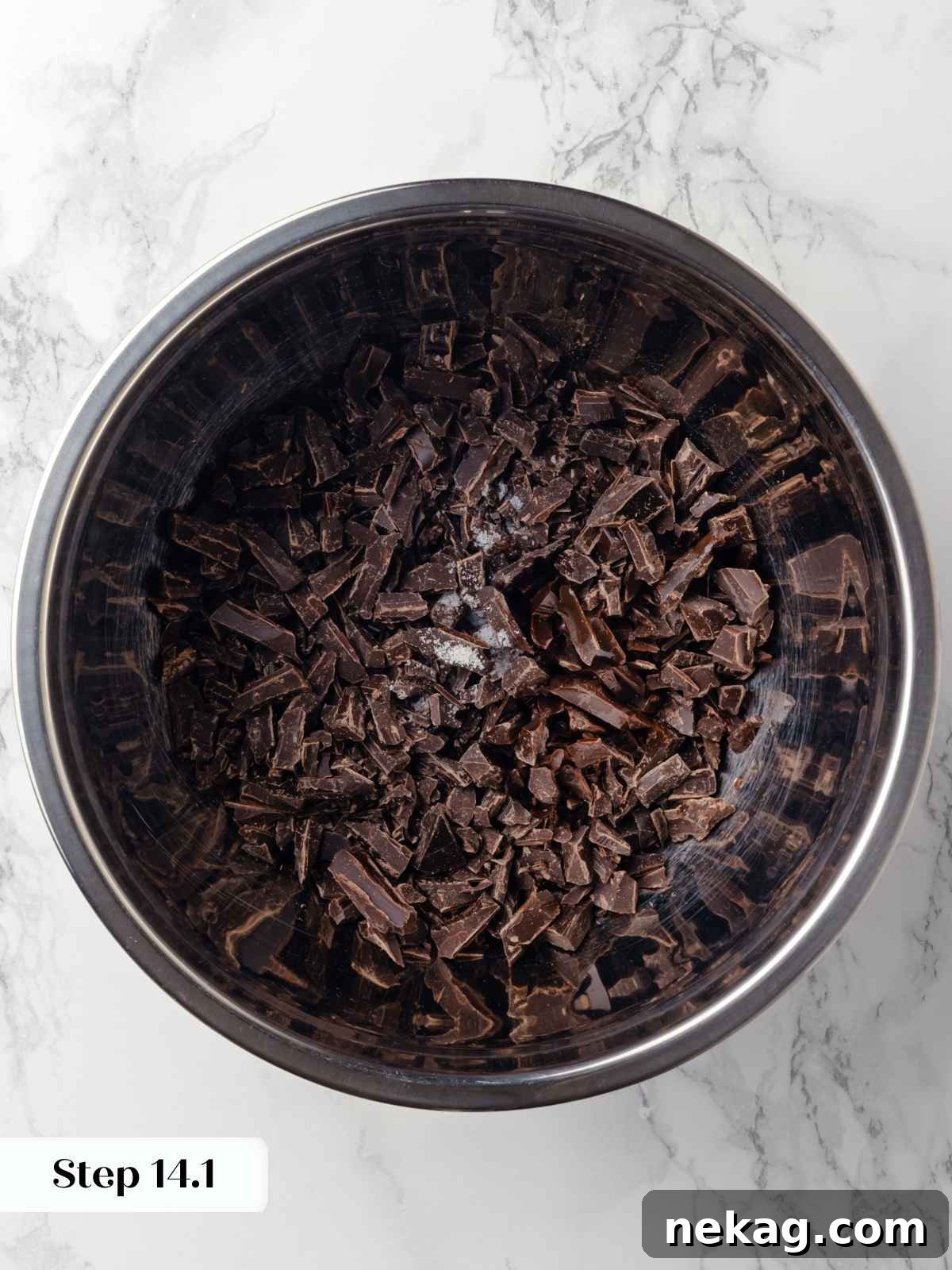 A mixing bowl with chopped dark chocolate, vanilla extract, corn syrup, and salt, perfectly portioned and ready for the next step.
