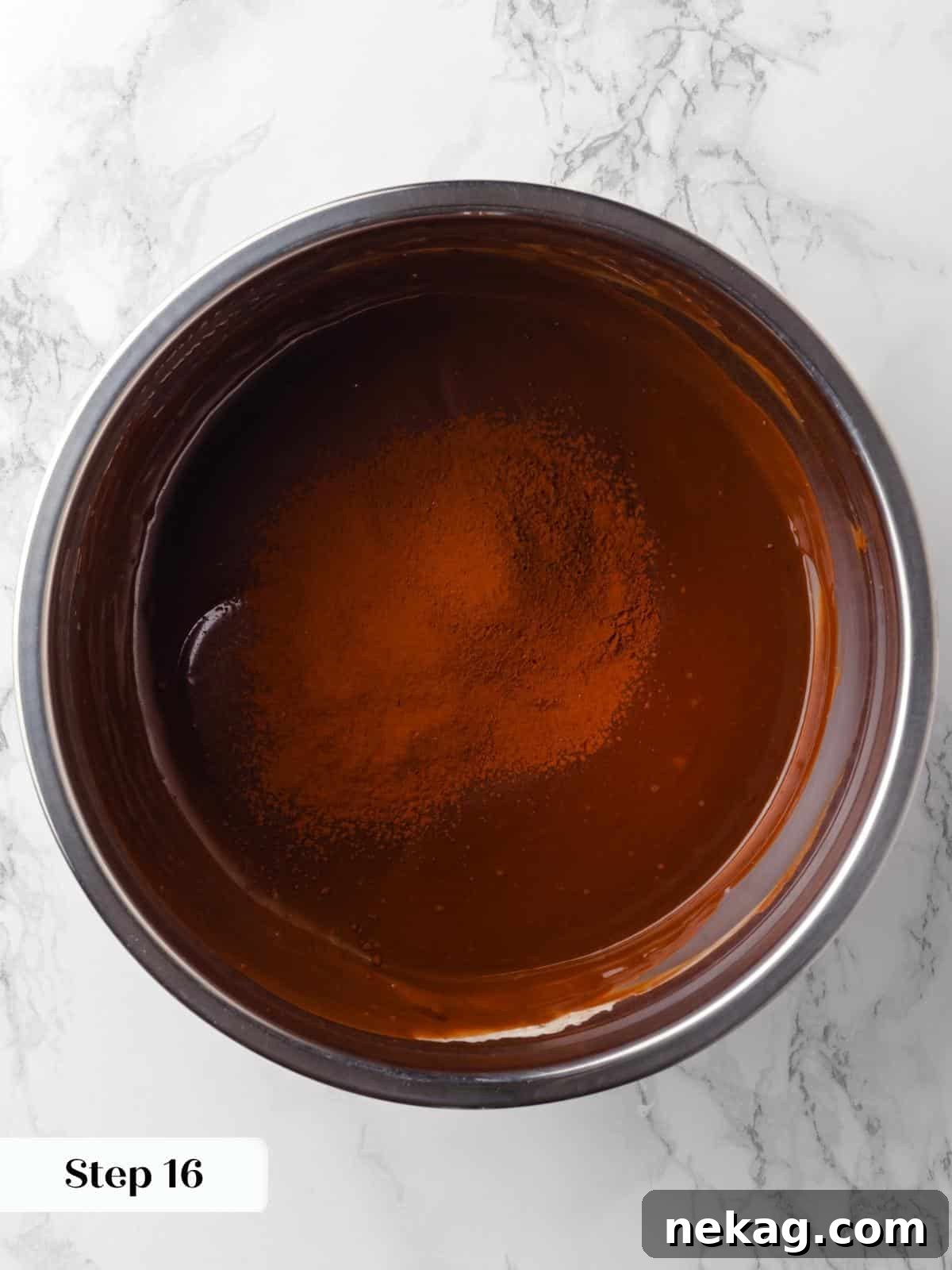 Cocoa powder being added to the dry ingredients for the chocolate raspberry cake, highlighting the fine texture.