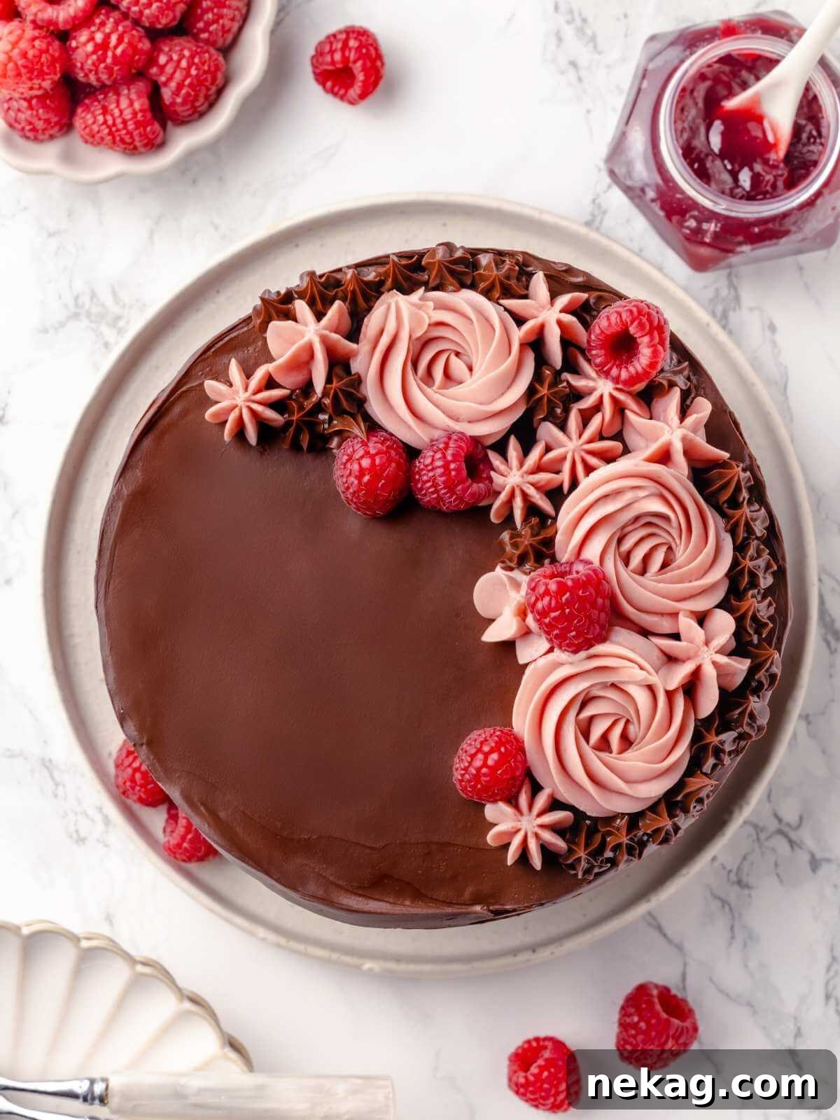 The chocolate raspberry cake fully decorated with pink frosting and fresh raspberries, a true masterpiece.