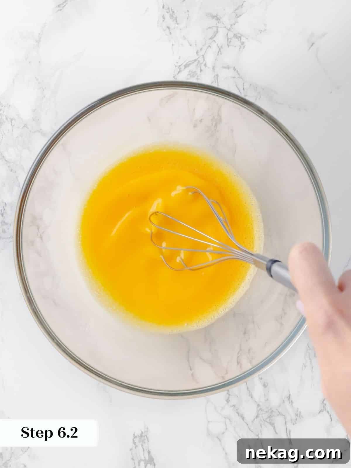 Silky Caramel Custard 11 Eggs being whisked in a mixing bowl to create a smooth custard base for creme caramel.