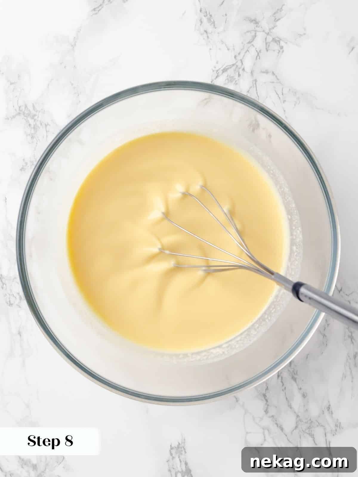 Silky Caramel Custard 13 Vanilla extract being whisked into a custard mixture for creme caramel.
