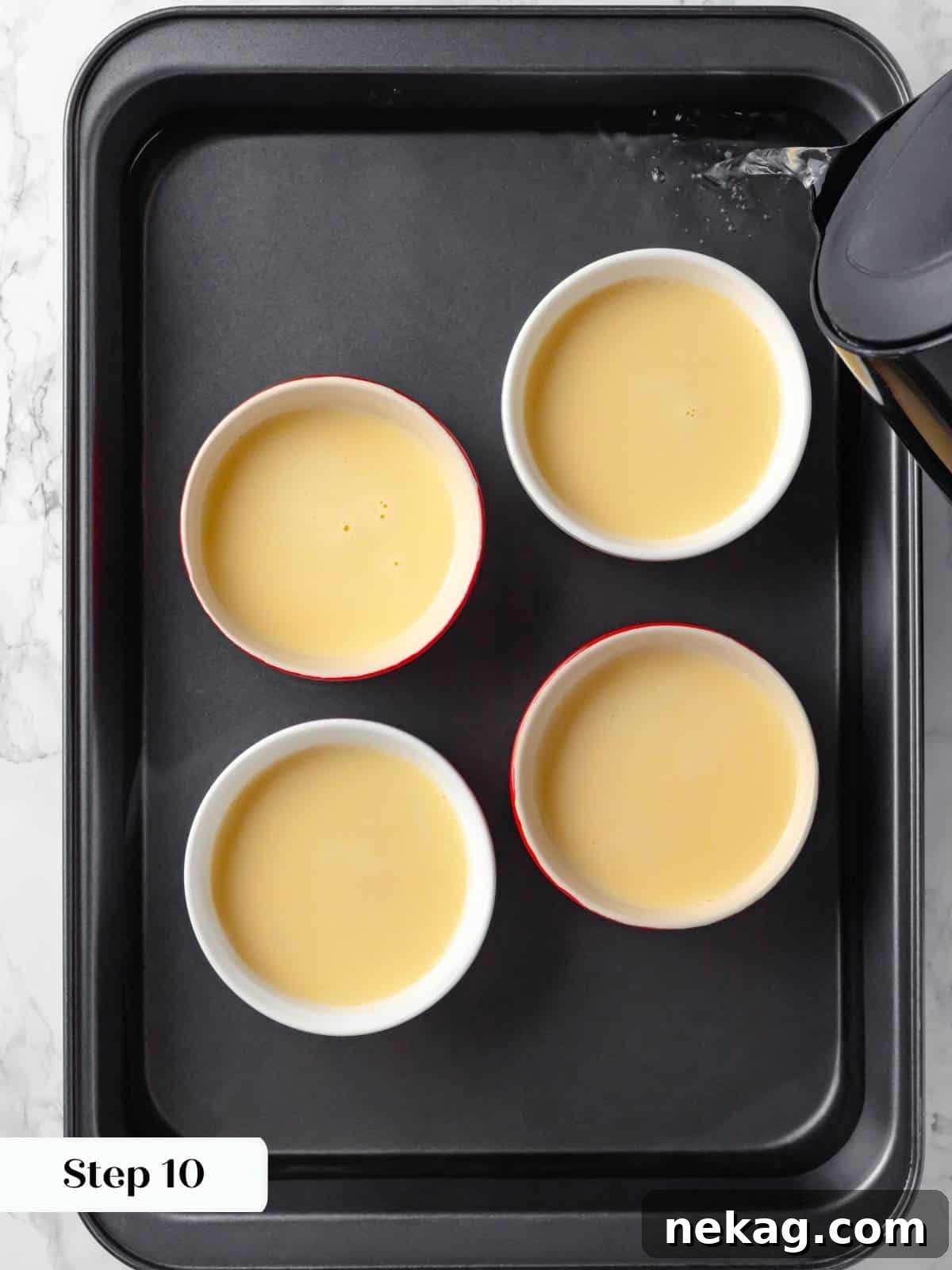 Silky Caramel Custard 14 Hot water being added to a baking pan for a water bath to gently bake the creme caramel.