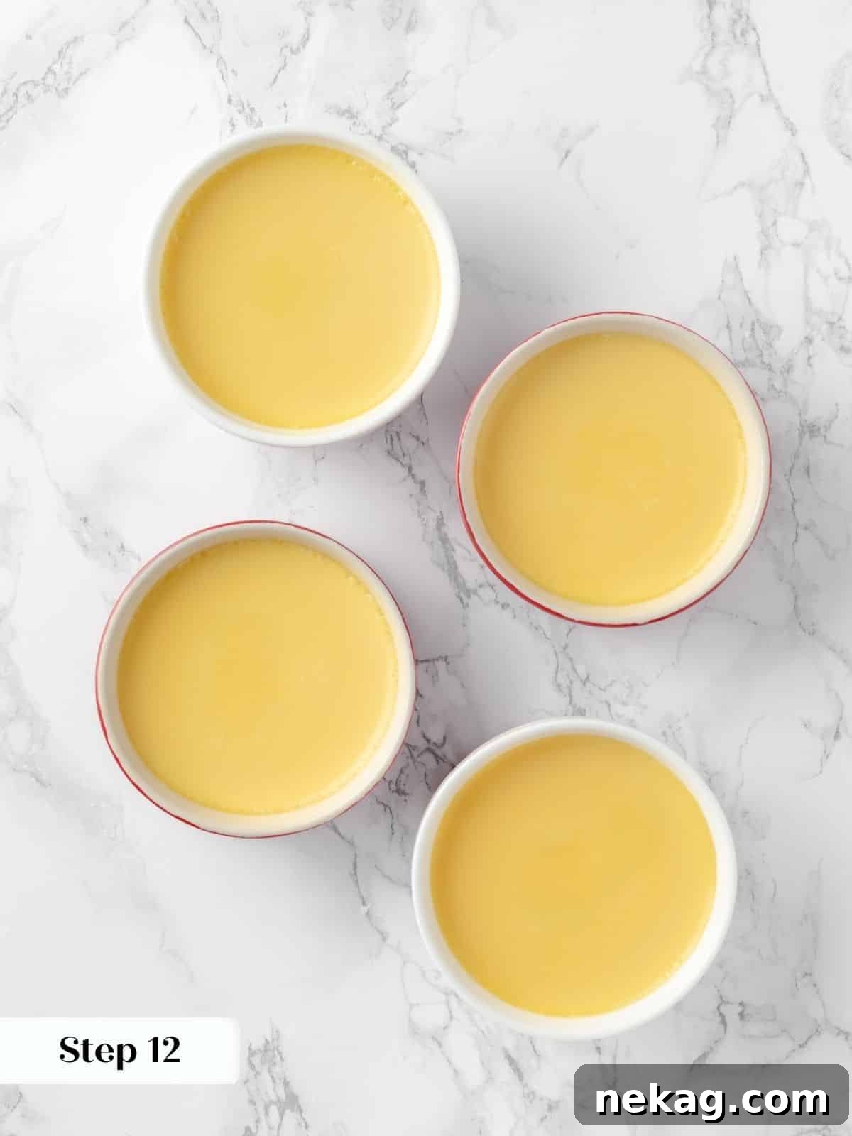 Silky Caramel Custard 15 Baked crème caramels cooling in a water bath.
