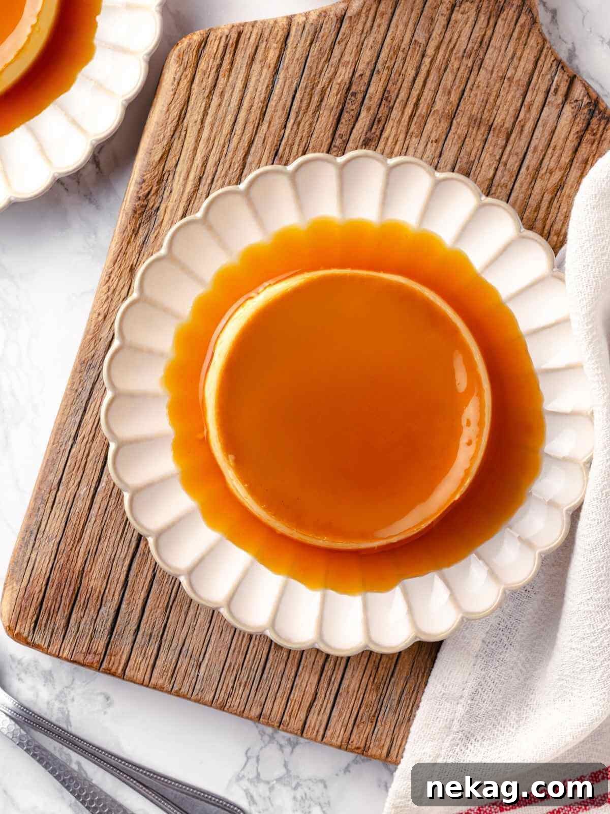 Silky Caramel Custard 16 A creme caramel portion inverted onto a white plate, showcasing its caramel topping.